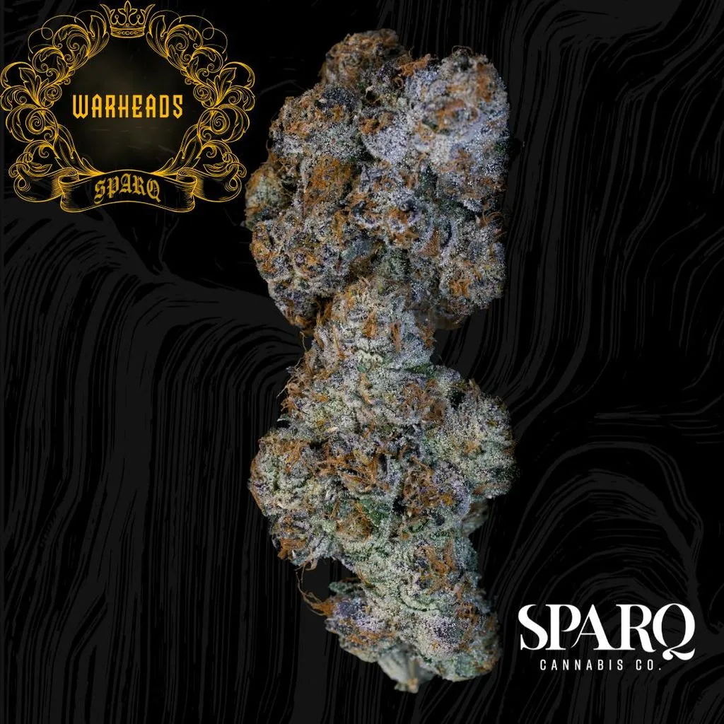 Dense purple-toned cannabis bud on a black swirl background, with a gold Warheads crest and the Sparq Cannabis Co. logo.